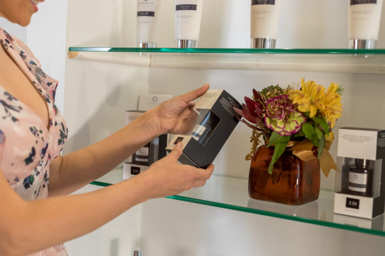 Patient browsing medical-grade skincare on the retail shelves at Accelerated Aesthetics in Elmhurst, IL