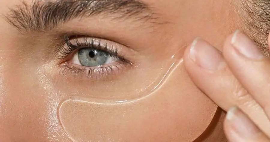 Woman applying a hydrogel under-eye patch, illustrating under-eye care at Accelerated Aesthetics in Elmhurst, IL